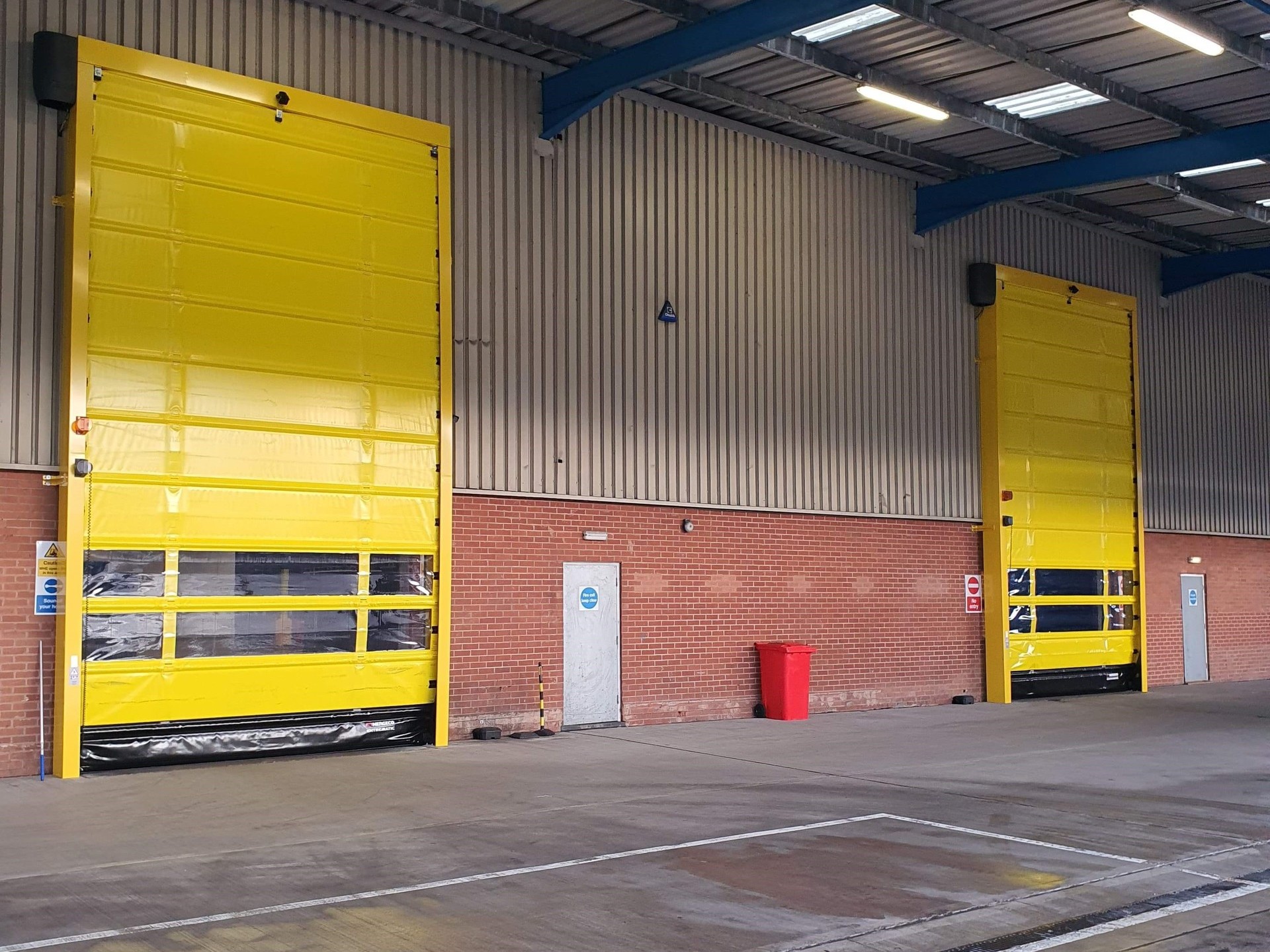 Pair of external fold up High Speed Doors in yellow