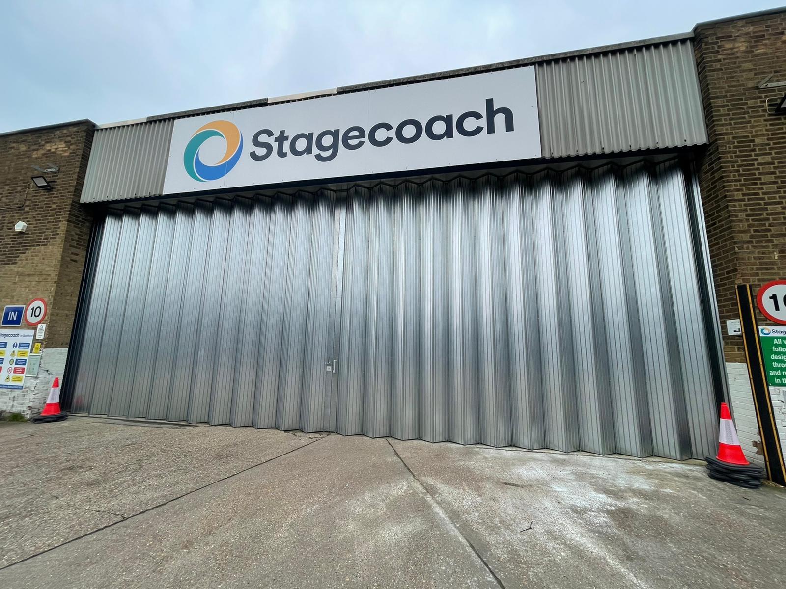 Large sliding folding door across bus storage terminal galvanised steel finish
