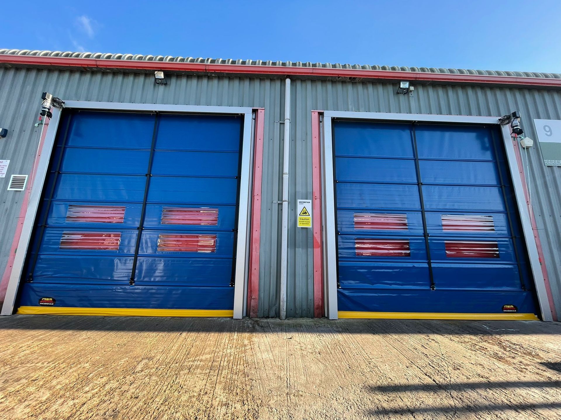 Pair of external High Speed/Rapid Action Doors at a food factory. Motor operated and including wind bars