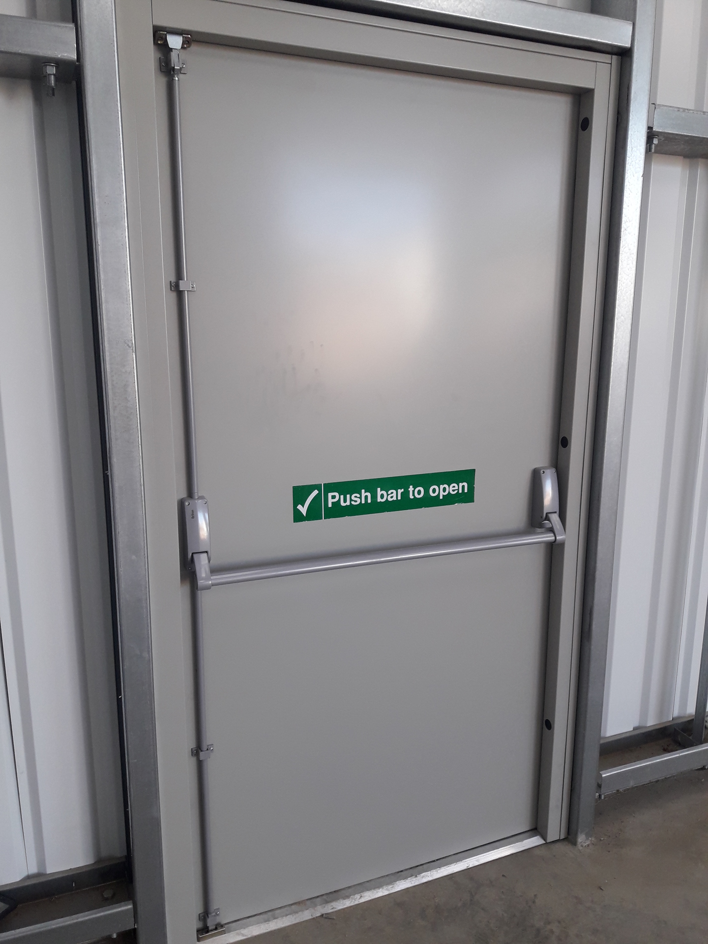 A fire exit door equipped with panic hardware