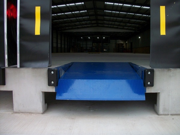 Telescopic Dock Leveller in closed position as installed by Stanair Industrial Doors. In situ in warehouse Loading Bay