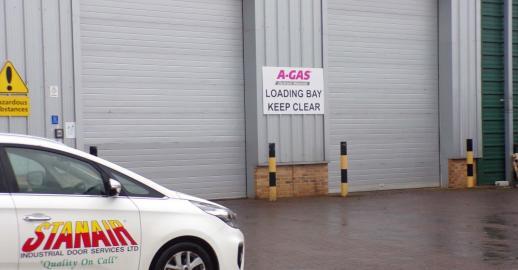 A Gas Rugby site exterior with two grey Insulated Roller Shutter Doors. Stanair car in the foreground